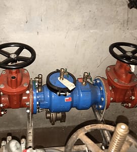 Plumber repairing backflow system in Monterey.