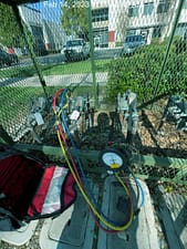Technician conducting backflow prevention device test with specialized equipment at a California Water Service utility site to ensure drinking water safety and regulatory compliance.