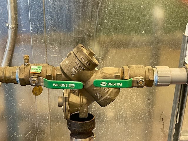 Image: A technician conducting backflow testing in Orinda, ensuring water safety and compliance with regulations.