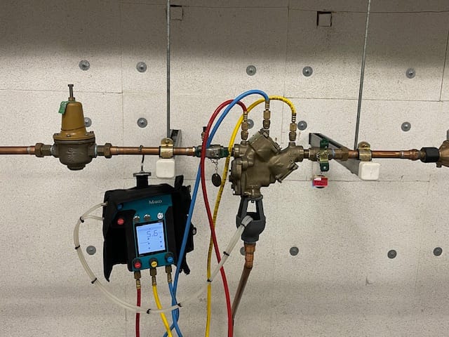 Image: Nashville Backflow Testing & Repair logo featuring a wrench and water droplets, symbolizing expertise and maintenance.